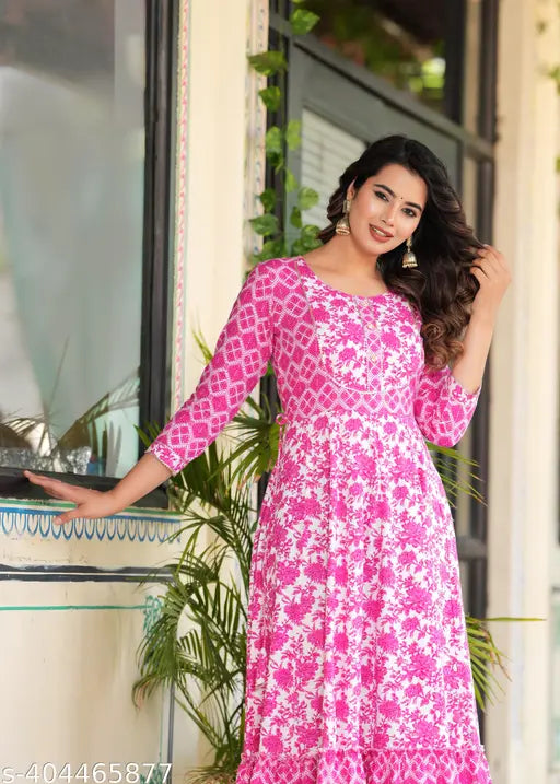 A pink color long-tired Dress Kurtis with an embroidered yoke Dresses and tassels sounds like a beautiful and vibrant garment This style of kurti combines various colors and textures to create a unique and eye-catching look The long tiers add an element