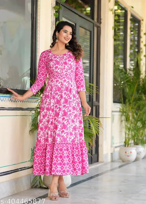 A pink color long-tired Dress Kurtis with an embroidered yoke Dresses and tassels sounds like a beautiful and vibrant garment This style of kurti combines various colors and textures to create a unique and eye-catching look The long tiers add an element