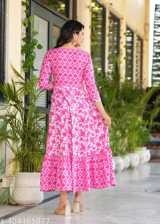 A pink color long-tired Dress Kurtis with an embroidered yoke Dresses and tassels sounds like a beautiful and vibrant garment This style of kurti combines various colors and textures to create a unique and eye-catching look The long tiers add an element